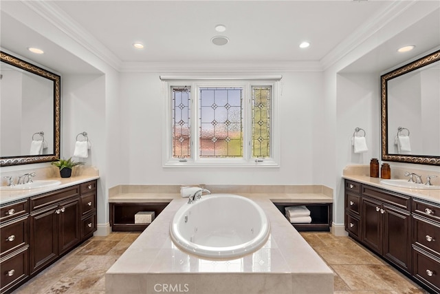 bathroom with vanity, crown molding, and tiled tub