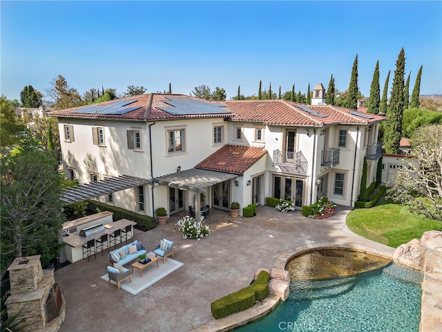 back of property featuring a patio area and exterior bar