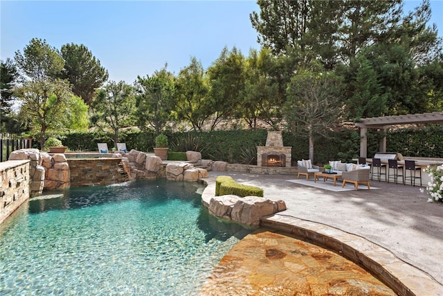 view of pool featuring an outdoor living space with a fireplace, pool water feature, a grill, a bar, and a patio