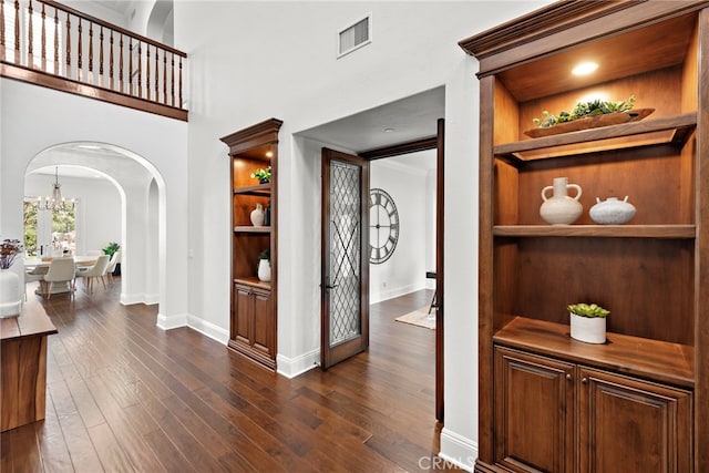 hallway with dark hardwood / wood-style flooring