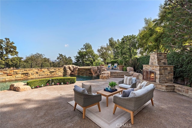 view of patio featuring an outdoor living space with a fireplace