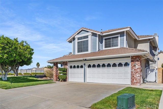 view of front of house featuring a front lawn and a garage