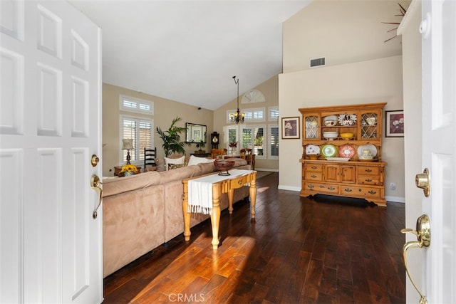 kitchen featuring dark hardwood / wood-style flooring, a chandelier, vaulted ceiling, and a wealth of natural light