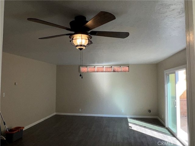 spare room featuring a textured ceiling, ceiling fan, and dark hardwood / wood-style floors