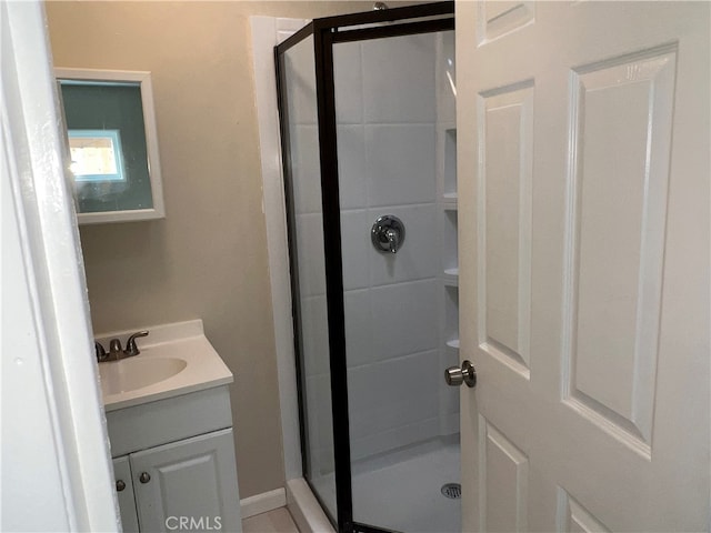 bathroom featuring vanity and a shower with door