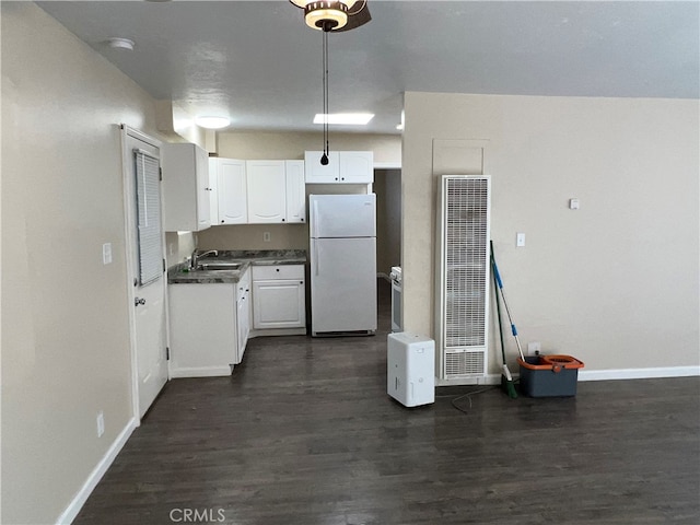 kitchen with dark hardwood / wood-style floors, white refrigerator, white cabinetry, and sink