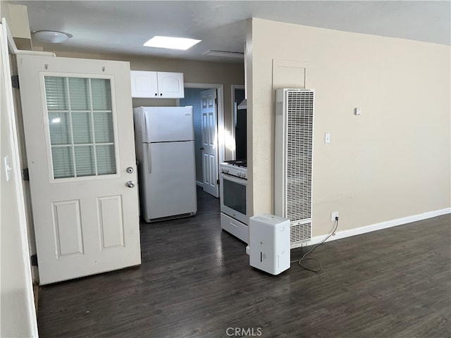 kitchen featuring white cabinets, dark hardwood / wood-style floors, white fridge, and high end stainless steel range oven