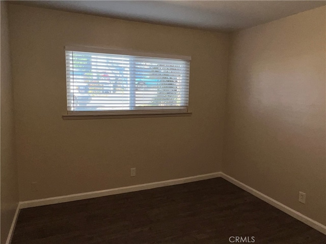 empty room with dark wood-type flooring