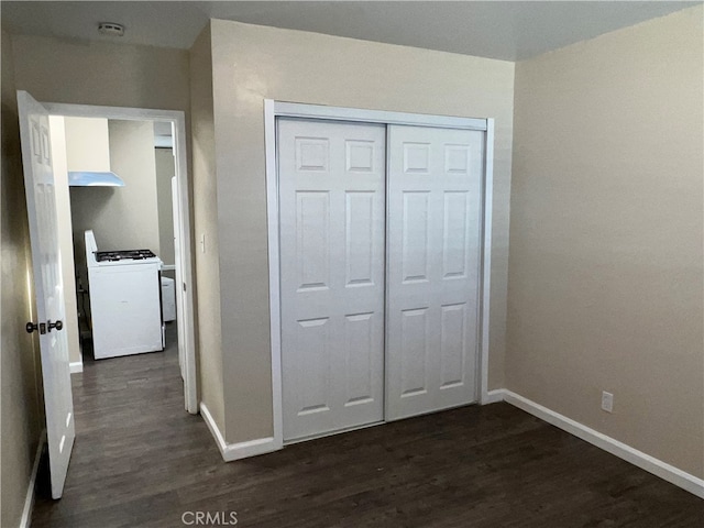 unfurnished bedroom featuring dark hardwood / wood-style flooring and a closet