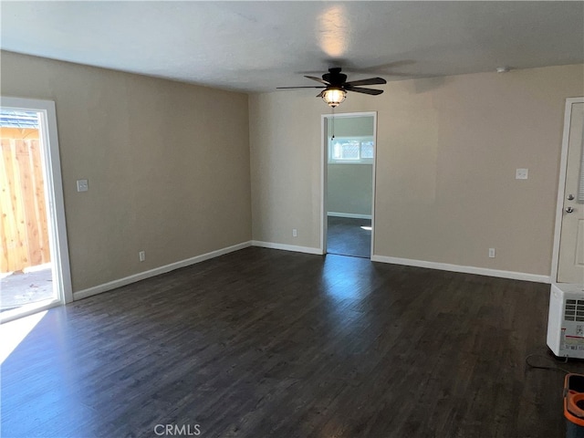 unfurnished living room with ceiling fan and dark wood-type flooring