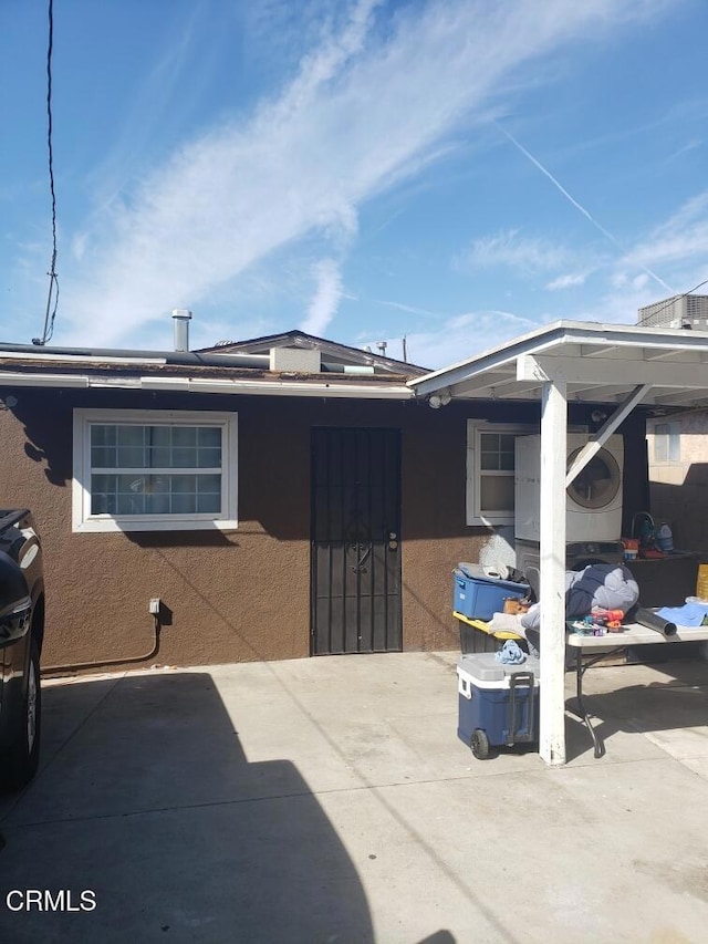back of house featuring a patio area and stucco siding