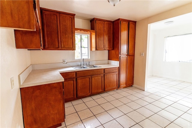 kitchen with sink and light tile patterned flooring