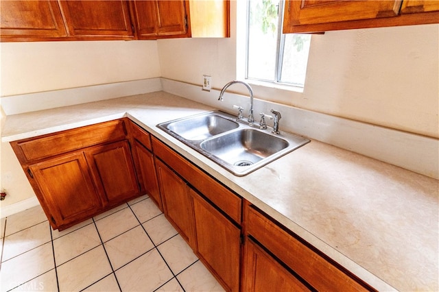 kitchen featuring sink and light tile patterned flooring