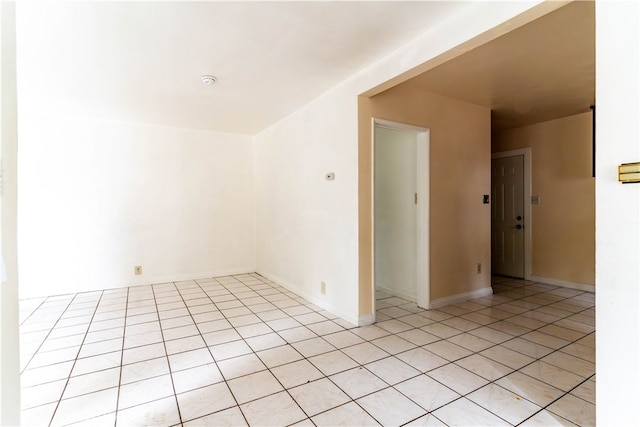 unfurnished room featuring light tile patterned flooring