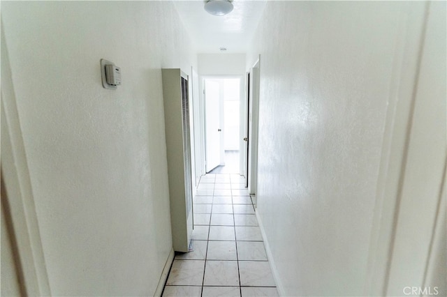 hall featuring light tile patterned floors