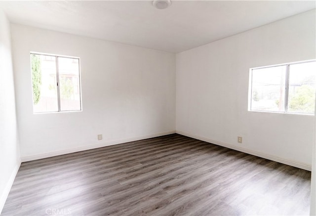 unfurnished room featuring dark hardwood / wood-style flooring