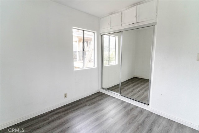 unfurnished bedroom with light hardwood / wood-style floors and a closet