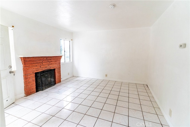 unfurnished living room featuring light tile patterned floors and a brick fireplace