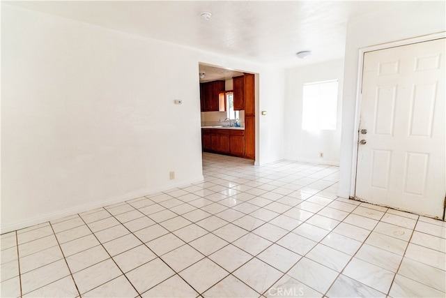 tiled spare room featuring sink