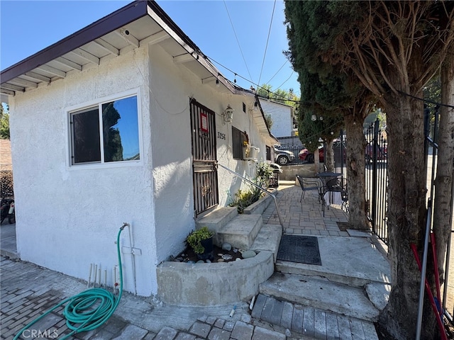 view of side of home featuring a patio area