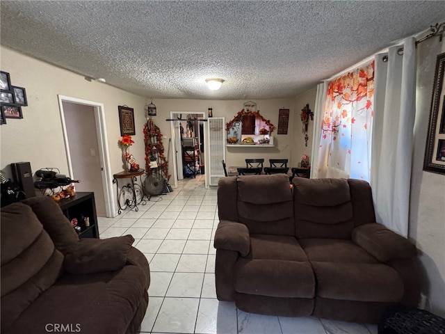 living room with a textured ceiling and light tile patterned flooring