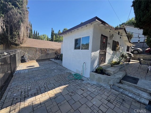 view of side of property featuring a patio area