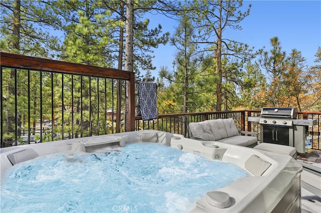 deck featuring a hot tub and area for grilling