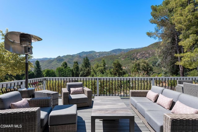 wooden terrace with a mountain view and an outdoor hangout area