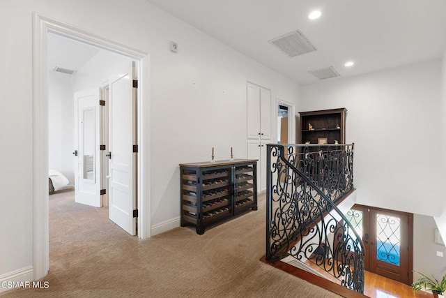 hallway with light carpet