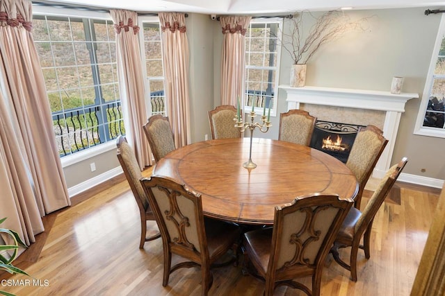 dining area with plenty of natural light and light hardwood / wood-style flooring