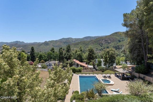 view of pool with a mountain view and a patio