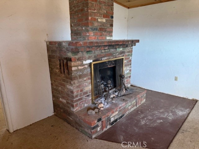 details featuring a fireplace and carpet floors