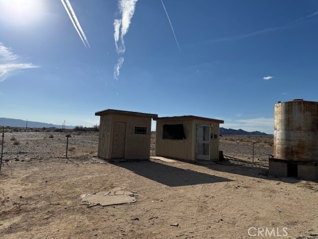 view of outbuilding with a mountain view and a rural view