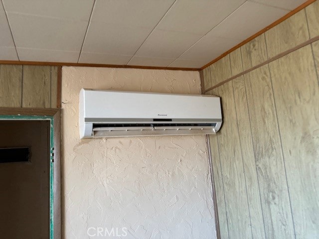 details featuring wooden walls and a wall unit AC