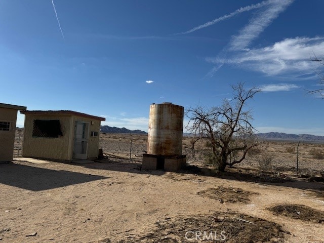 view of yard with a mountain view and a rural view