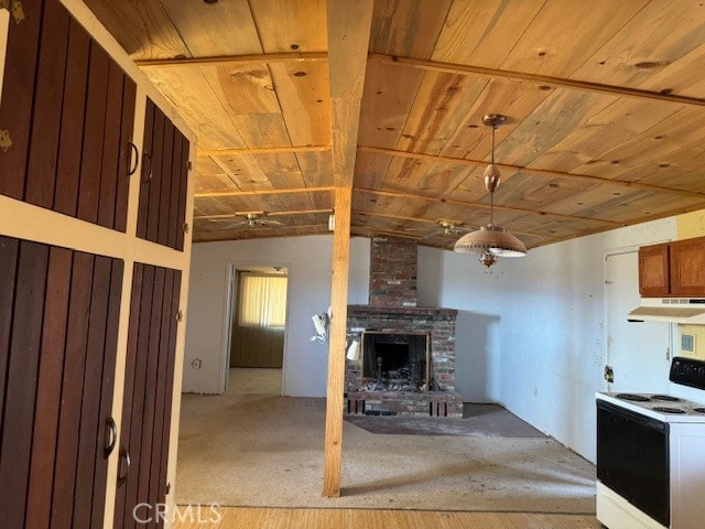 interior space featuring vaulted ceiling, a fireplace, electric stove, light hardwood / wood-style floors, and decorative light fixtures