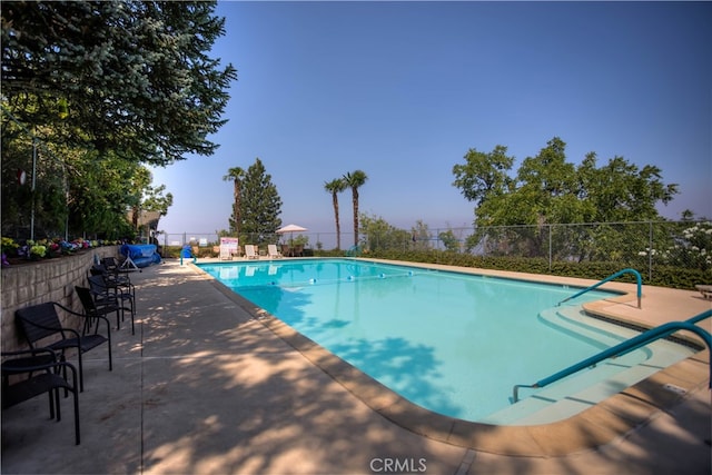 view of swimming pool featuring a patio area