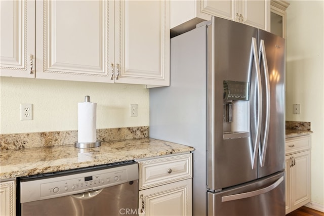 kitchen with light stone countertops and appliances with stainless steel finishes