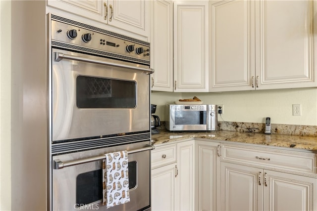 kitchen featuring light stone countertops and stainless steel appliances