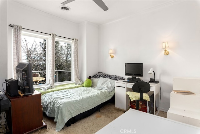 carpeted bedroom featuring ornamental molding and ceiling fan