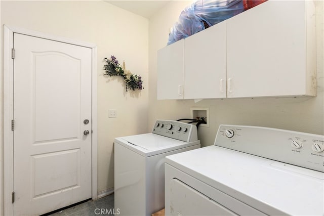 laundry room featuring washing machine and clothes dryer and cabinets