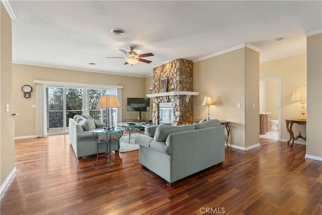 living room featuring ceiling fan, a fireplace, ornamental molding, and dark hardwood / wood-style floors