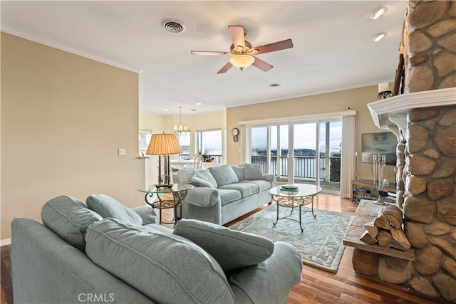 living room with ornamental molding, hardwood / wood-style floors, and ceiling fan