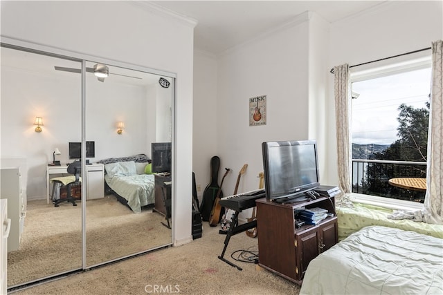 carpeted bedroom featuring a closet and ornamental molding