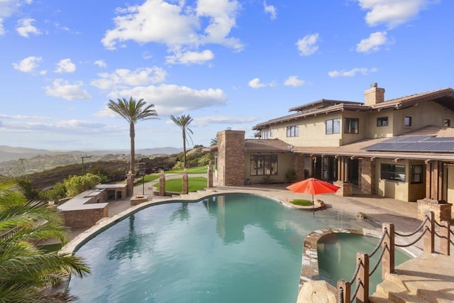 view of pool featuring a patio area and an in ground hot tub