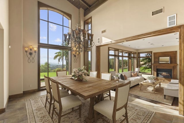 dining area with a high ceiling and a notable chandelier