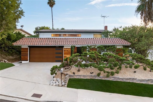 7385 Darnoch Way, West Hills, CA 91307 - view of front facade featuring concrete driveway, a tiled roof, and an attached garage