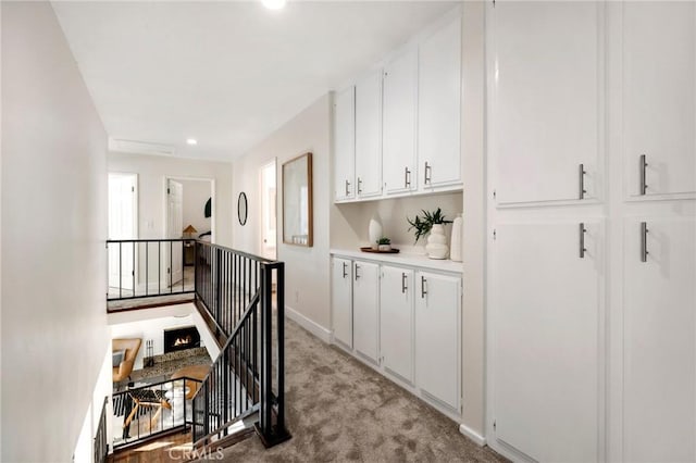 hallway with light colored carpet