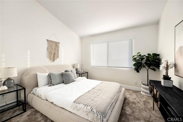 carpeted bedroom with lofted ceiling