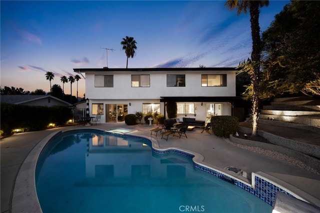 7385 Darnoch Way, West Hills, CA 91307 - pool at dusk featuring a patio, an outdoor hangout area, and an outdoor pool